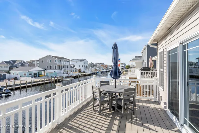 a aerial view of a house with swimming pool and outdoor seating