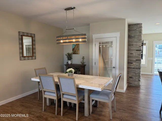 a view of a dining room with furniture wooden floor and chandelier