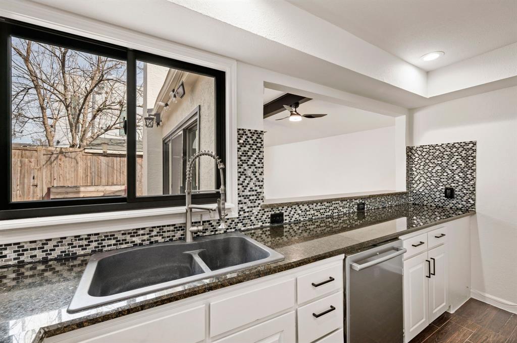 5009 Milam Street Dallas, TX 75206 - Photo 9 of 35 Kitchen featuring white cabinets, stainless steel dishwasher, wood finish floors, dark stone counters, and ceiling fan
