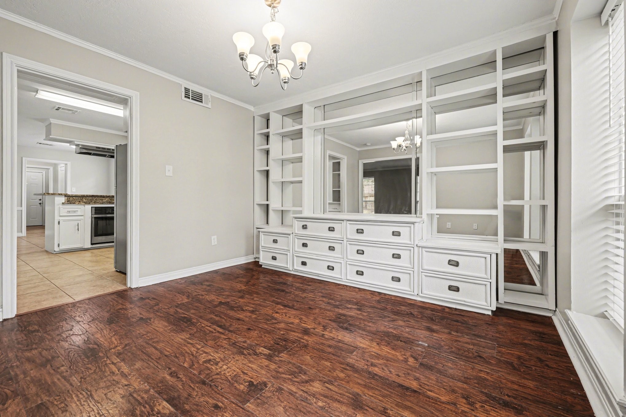 107 Carriage Lane Conroe, TX 77385 - Photo 11 of 26 wooden floor in an empty room with a mirror