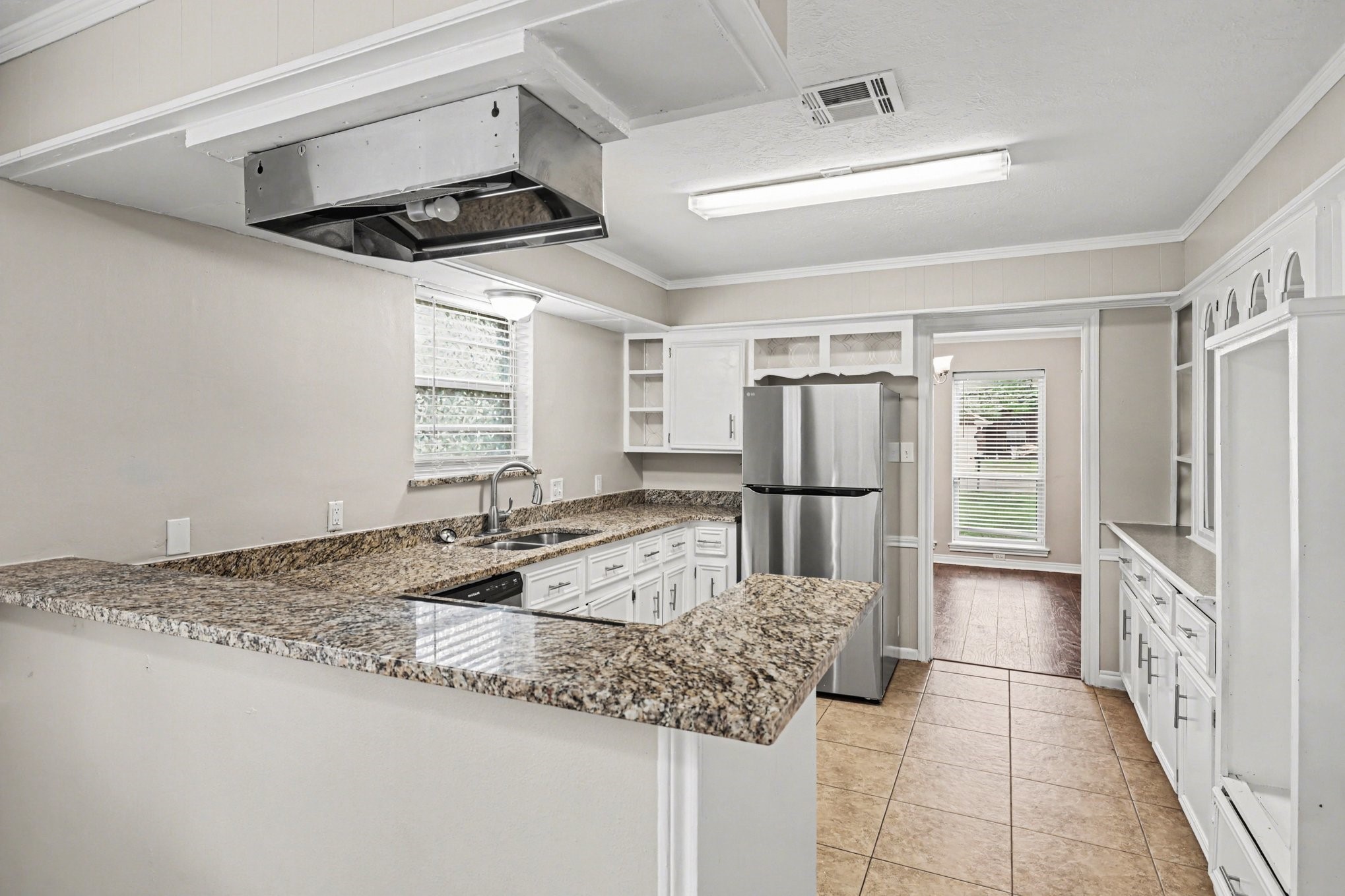 107 Carriage Lane Conroe, TX 77385 - Photo 14 of 26 a kitchen with granite countertop a sink stainless steel appliances and cabinets