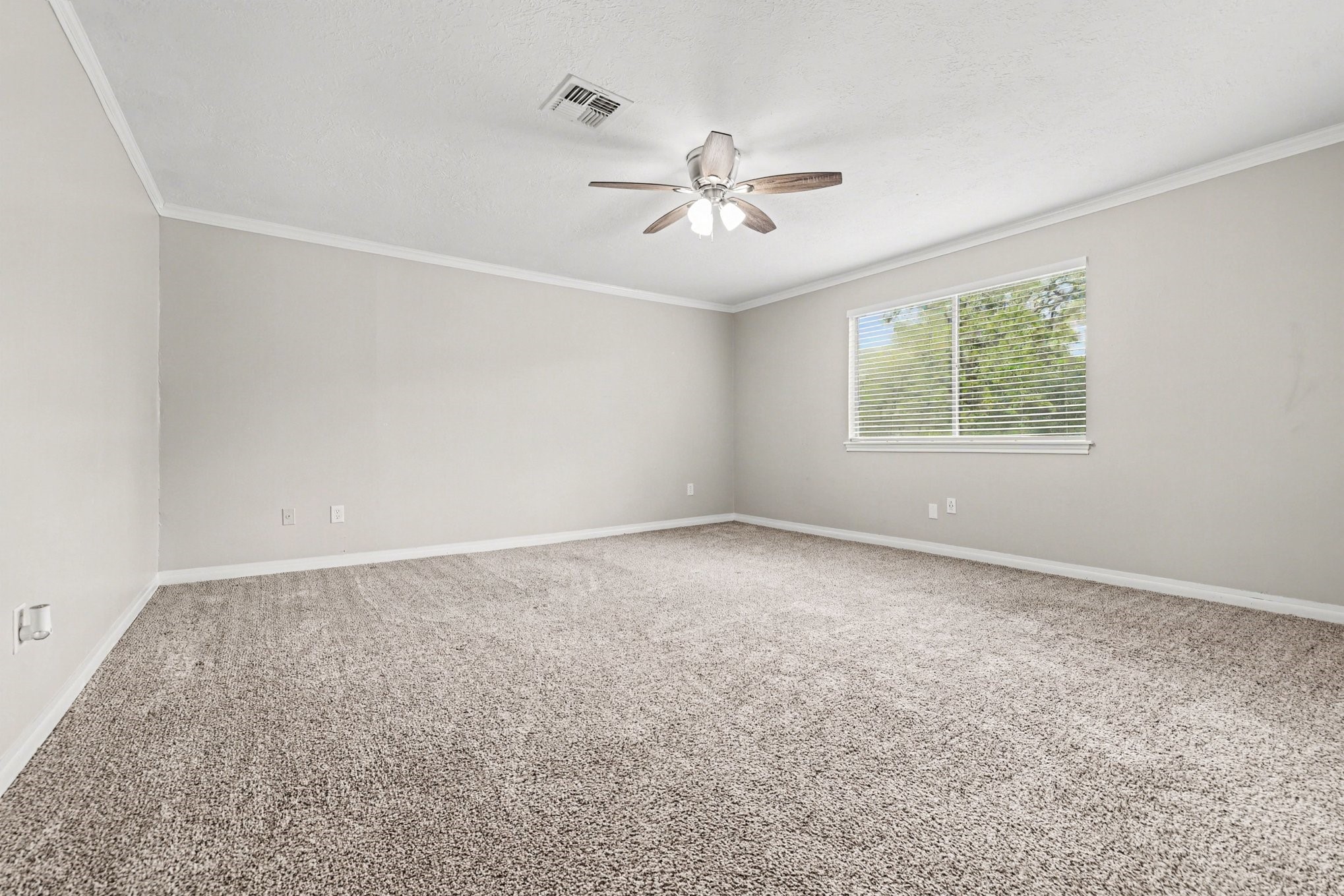 107 Carriage Lane Conroe, TX 77385 - Photo 18 of 26 an empty room with windows and fan