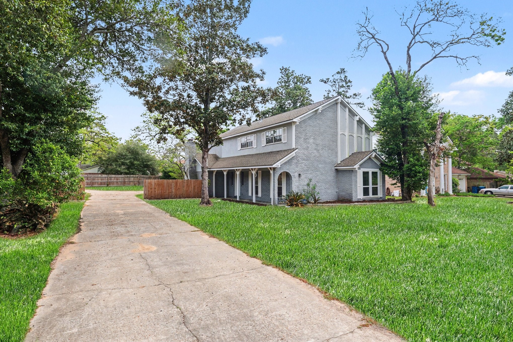 107 Carriage Lane Conroe, TX 77385 - Photo 2 of 26 a view of house with outdoor space and garden
