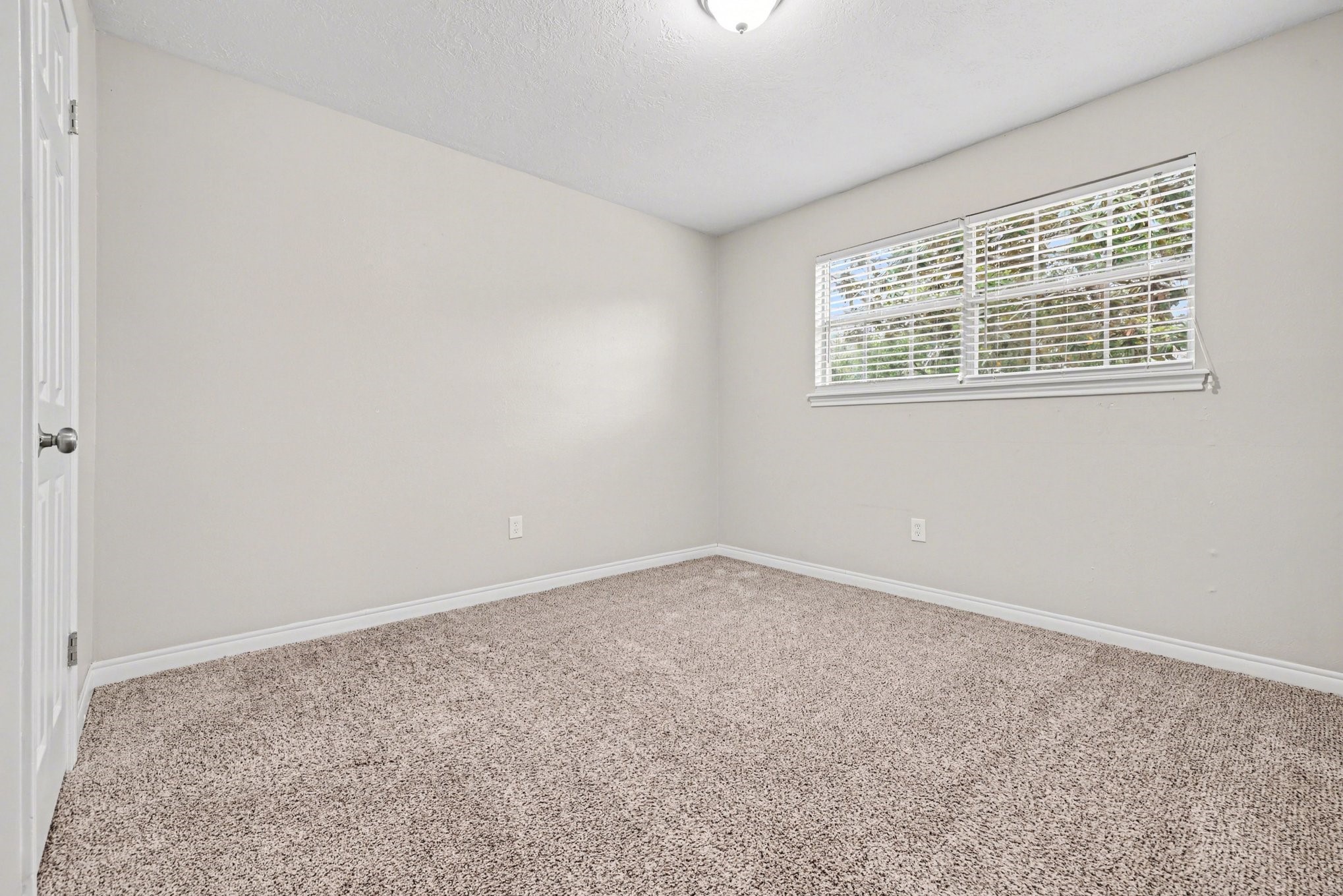 107 Carriage Lane Conroe, TX 77385 - Photo 21 of 26 an empty room with a window