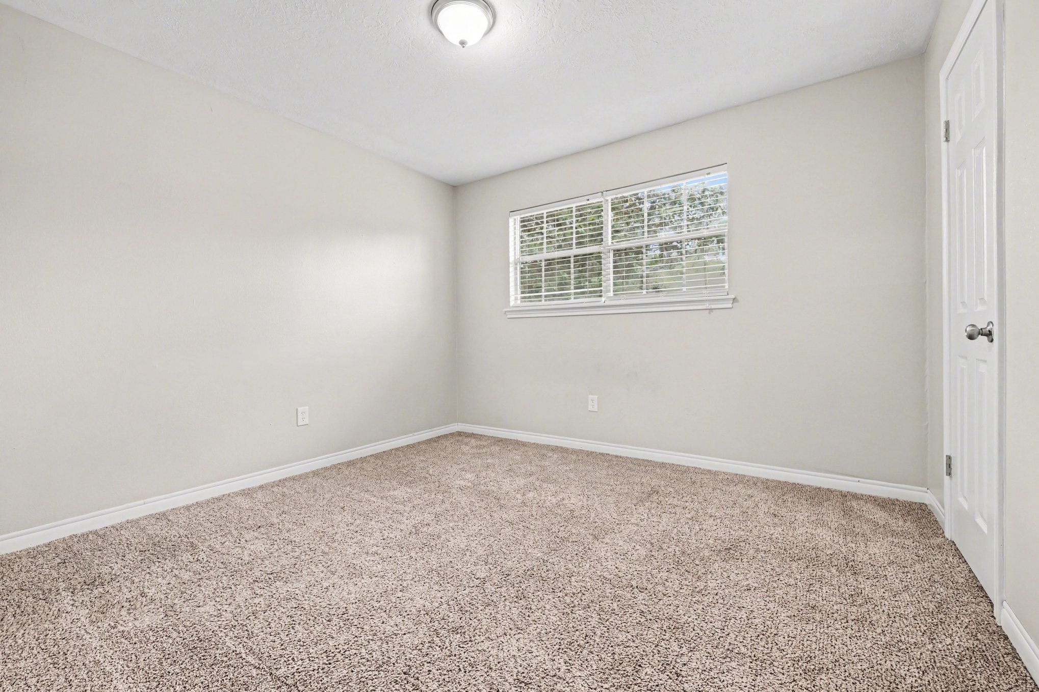 107 Carriage Lane Conroe, TX 77385 - Photo 22 of 26 an empty room with a window