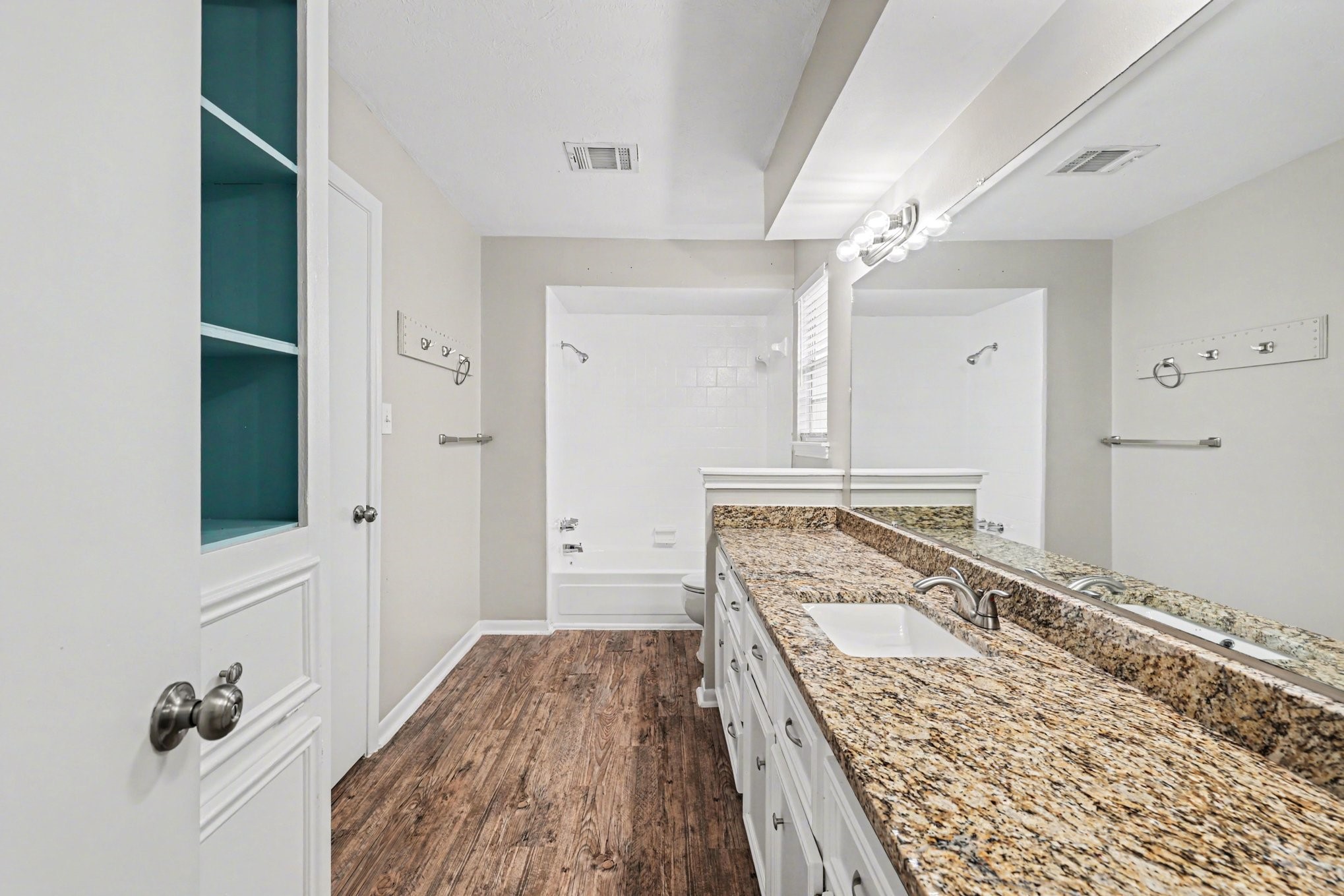 107 Carriage Lane Conroe, TX 77385 - Photo 23 of 26 a spacious bathroom with a granite countertop sink and a mirror