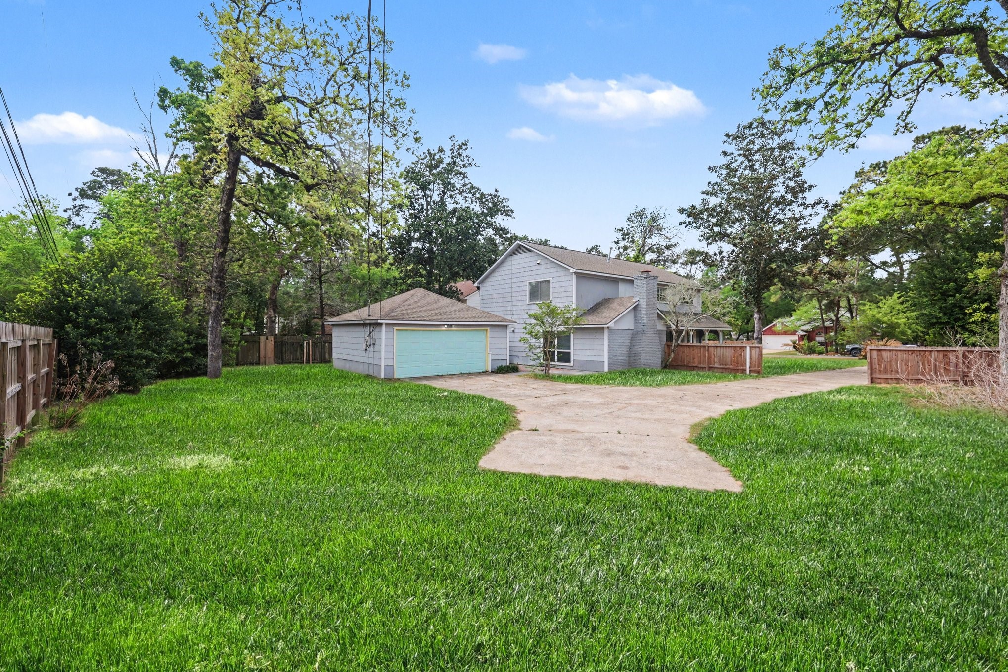 107 Carriage Lane Conroe, TX 77385 - Photo 26 of 26 a view of a house with backyard and garden