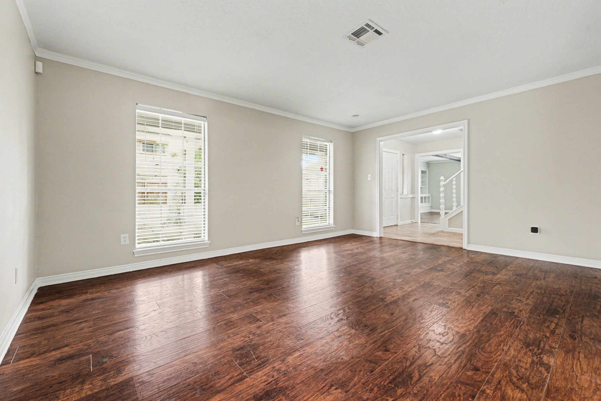 107 Carriage Lane Conroe, TX 77385 - Photo 8 of 26 a view of an empty room with wooden floor and a window