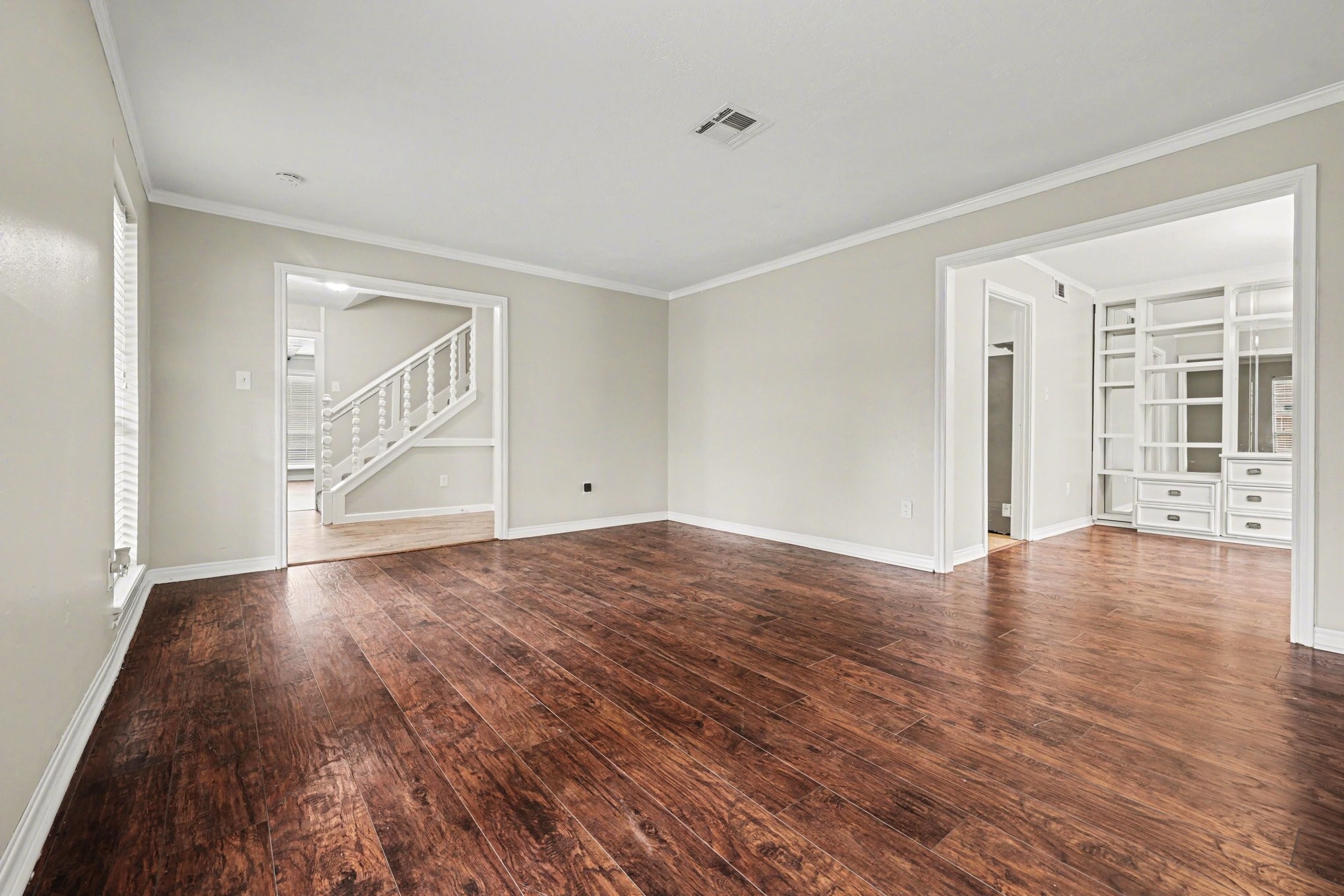 107 Carriage Lane Conroe, TX 77385 - Photo 9 of 26 wooden floor in an empty room with a window