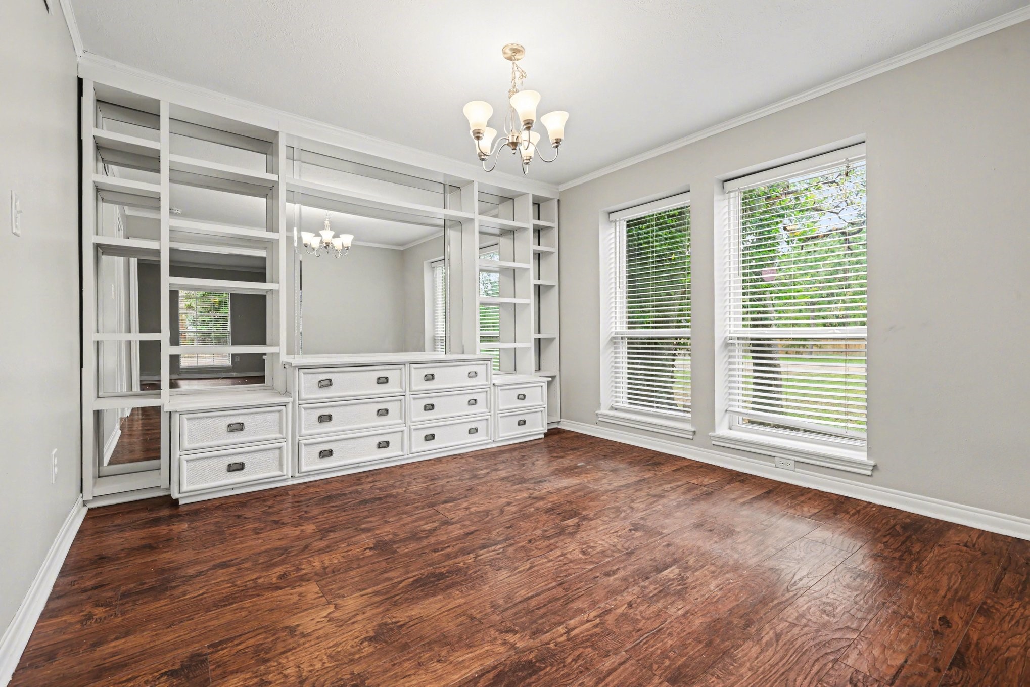 107 Carriage Lane Conroe, TX 77385 - Photo 10 of 26 a view of a big room with windows and chandelier