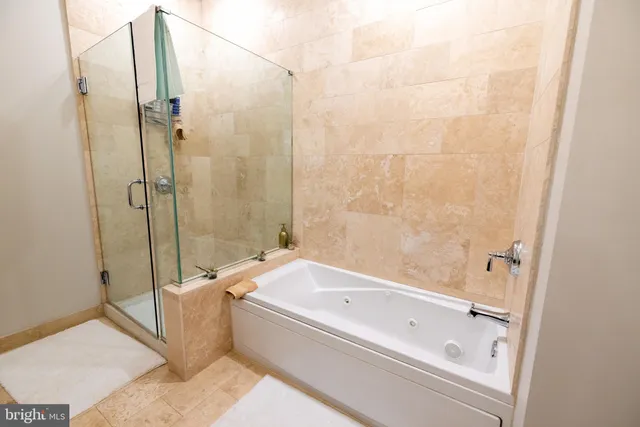 a bed sitting in a bedroom next to a window with potted plant