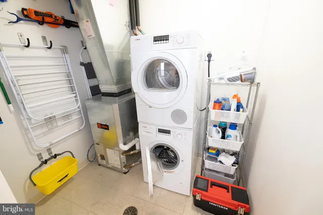 a kitchen with stainless steel appliances a stove a refrigerator and wooden cabinets