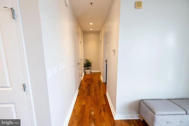 a living room with furniture a flat screen tv and a large window