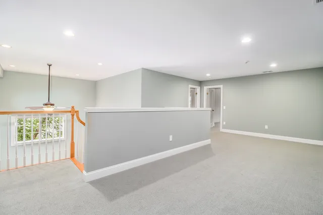 an empty room with windows and closet