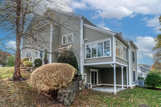 a view of a house with a yard and plants