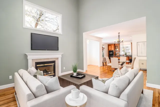 a living room with furniture a fireplace and a flat screen tv