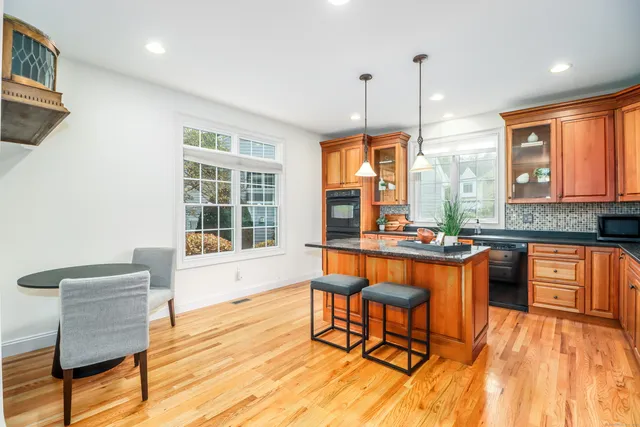 a large kitchen with a table and chairs