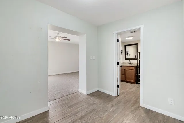 a spacious bedroom with a bed and a ceiling fan