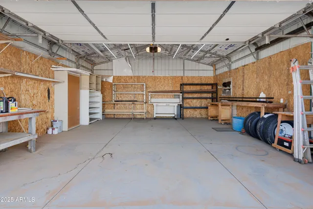 a view of an empty room with wooden floor fireplace and a window