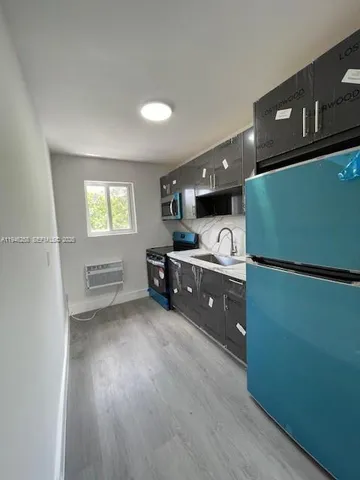 a kitchen with stainless steel appliances granite countertop a refrigerator a sink dishwasher a stove and a refrigerator