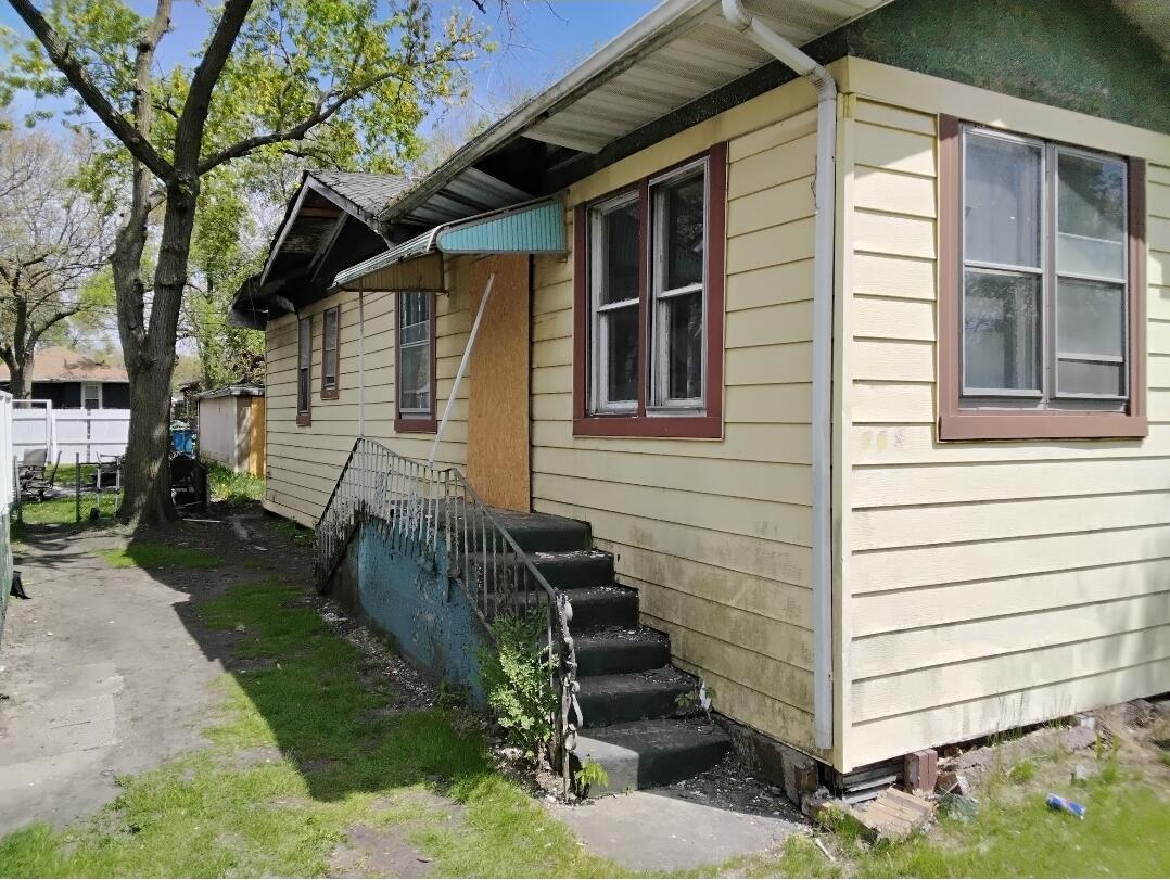 823 Pierce Street Gary, IN 46402 - Photo 1 of 6 a view of a house with a yard