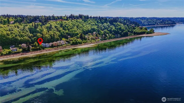 an aerial view of a house with a garden and lake view