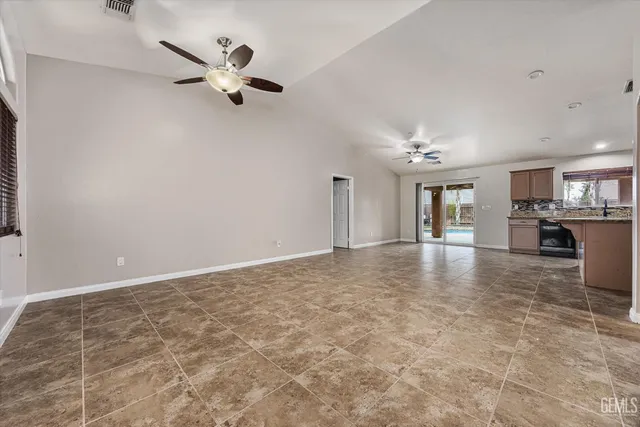 a view of a livingroom with a ceiling fan and window