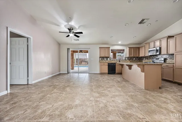 a view of kitchen with microwave and cabinets