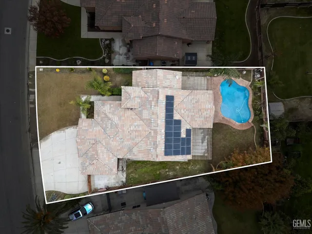 an aerial view of residential houses with city view