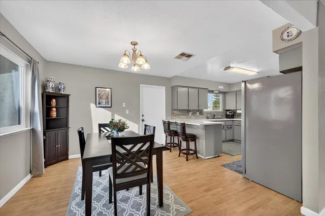 a view of a dining room with furniture and a kitchen