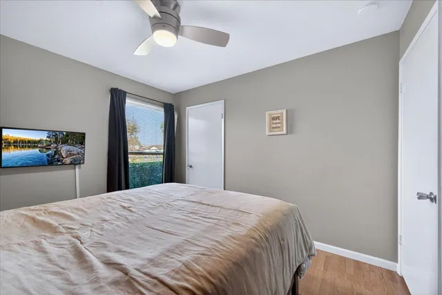 a bedroom with a large bed and a chandelier