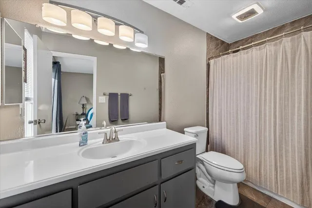 a bathroom with a sink vanity and a mirror