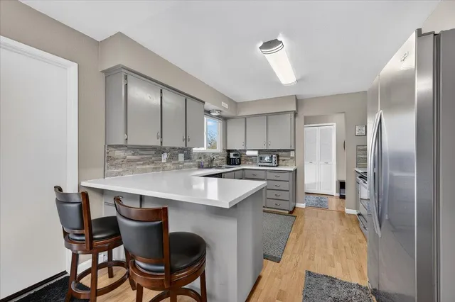 a kitchen with kitchen island a sink stove and refrigerator