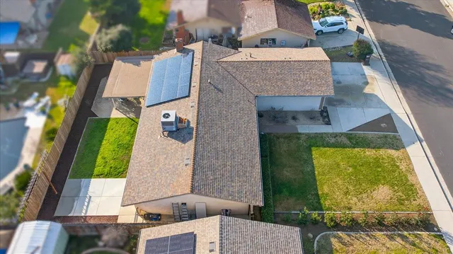 an aerial view of a house with a swimming pool
