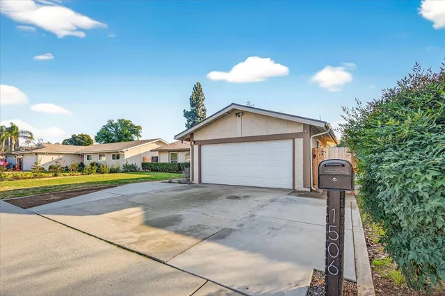 a view of a house with a yard and garage