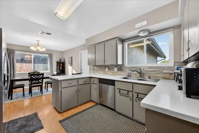 a kitchen with a sink stove and cabinets