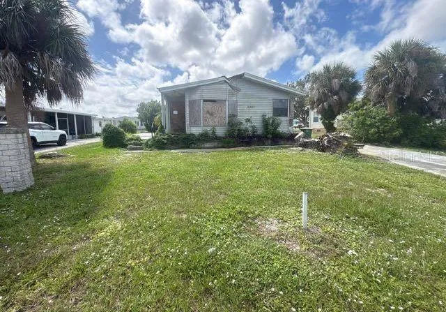 a view of backyard of house and green space