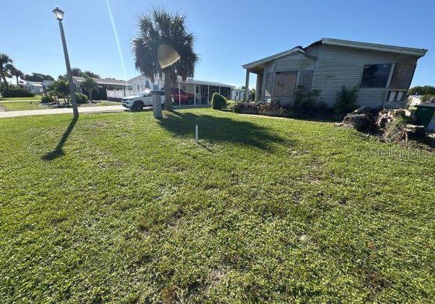 8407 Buttonquail Drive Englewood, FL 34224 - Photo 5 of 5 a house view with a seating space and garden