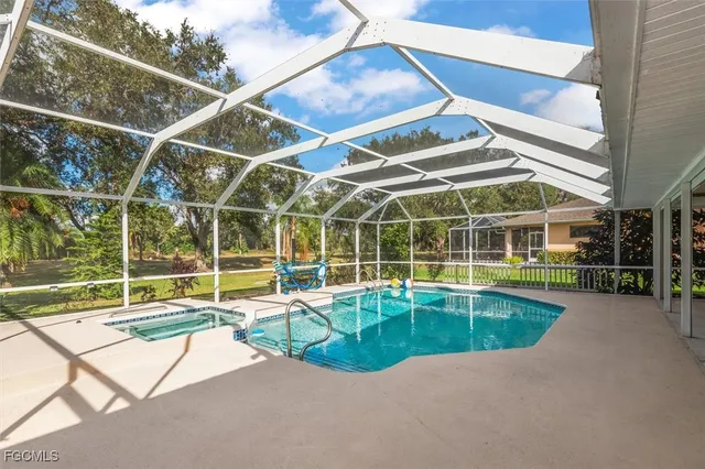a view of a swimming pool with a yard and potted plants