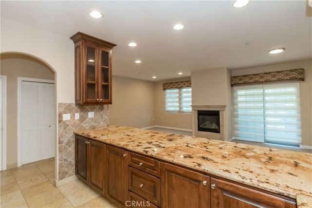 a view of kitchen with granite countertop sink and dishwasher