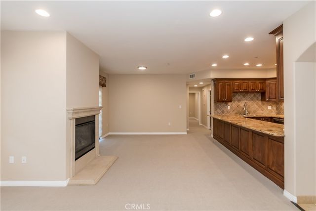a view of an empty room with a fireplace