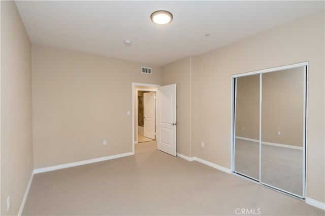 an empty room with closet and a window