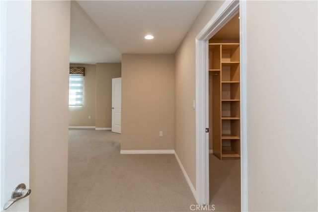 an empty room with closet and windows