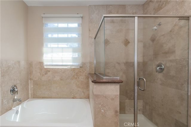 a bathroom with a shower and a bath tub