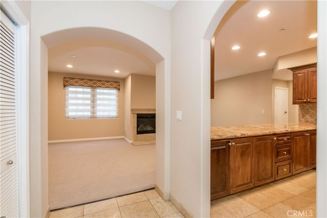 a view of a kitchen with stainless steel appliances granite countertop a refrigerator and a sink