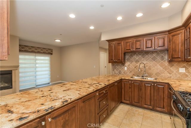 a kitchen with stainless steel appliances granite countertop a sink stove and cabinets
