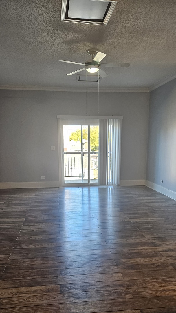 7850 West Addison Street, Unit 202 Chicago, IL 60634 - Photo 2 of 6 a view of an empty room with wooden floor and a window