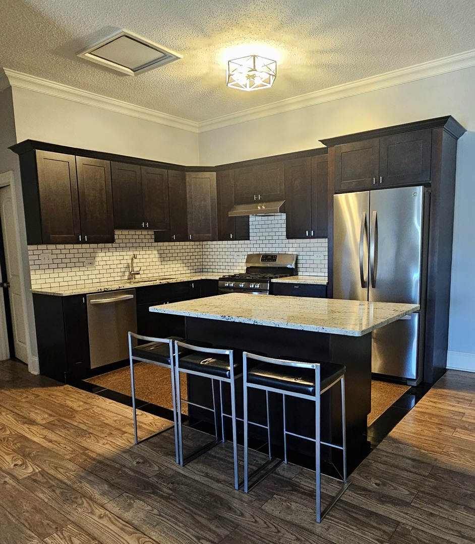 7850 West Addison Street, Unit 202 Chicago, IL 60634 - Photo 3 of 6 a kitchen with a stove and a refrigerator
