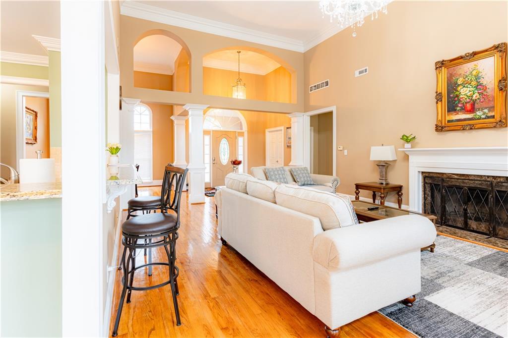 8105 Jot Em Down Road Gainesville, GA 30506 - Photo 18 of 73 a living room with furniture a fireplace and a flat screen tv
