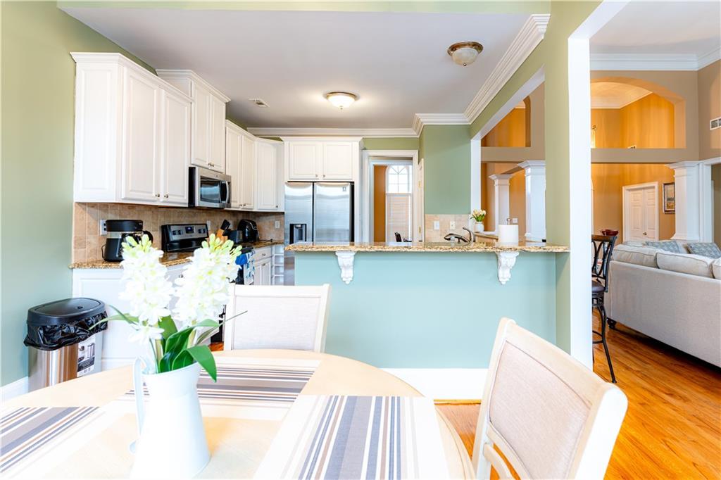 8105 Jot Em Down Road Gainesville, GA 30506 - Photo 22 of 73 a kitchen with stainless steel appliances kitchen island granite countertop a refrigerator and a sink